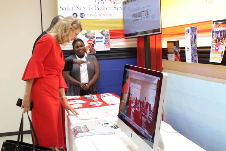 High Commissioner Peters looks keenly at a media campaign project on “Cyberbulling” by final year BACAT student Jhenelle Lewis. Looking on is final year student, Joneal Crawford. 